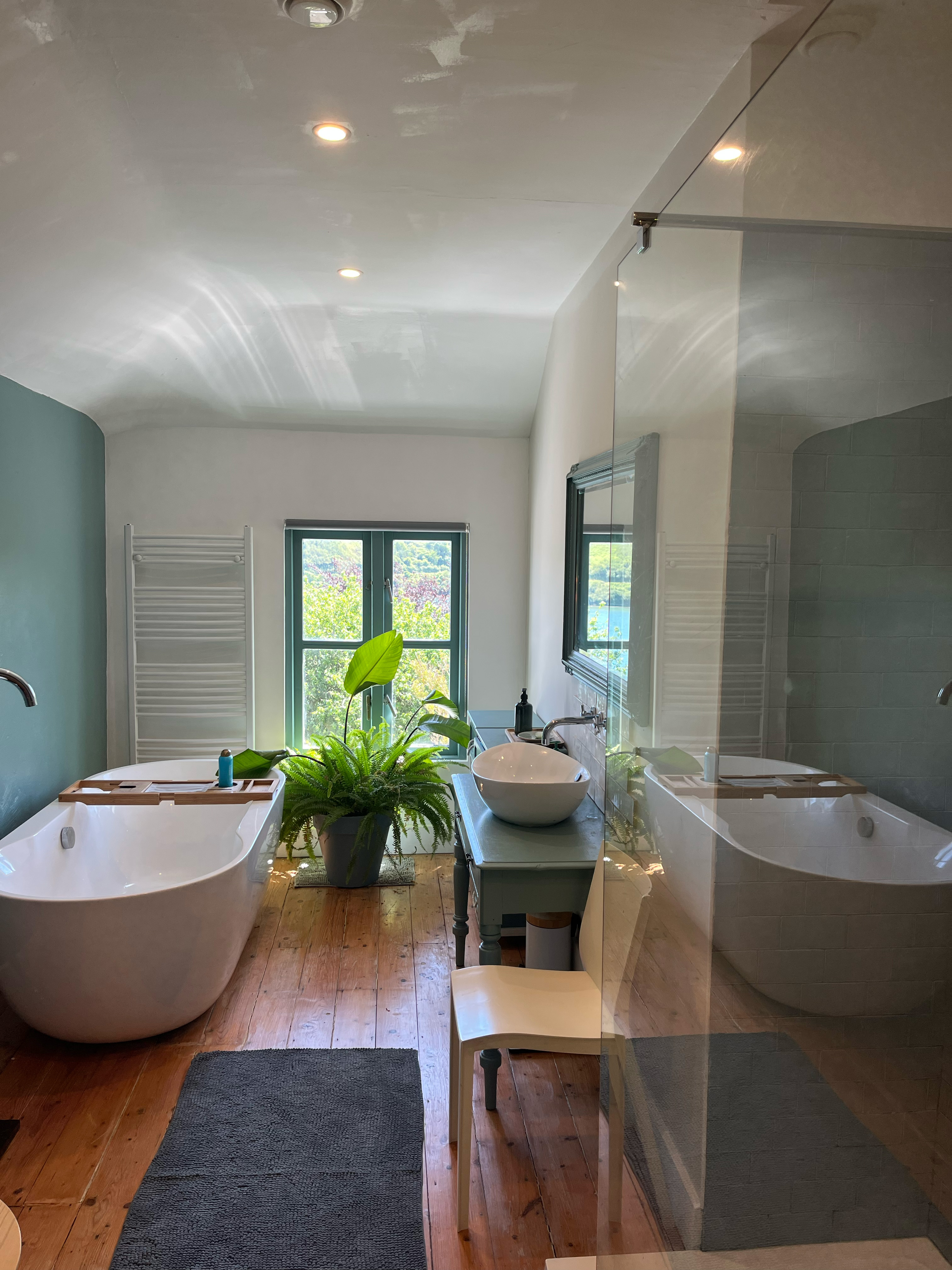 Bathroom with freestanding bath and river view